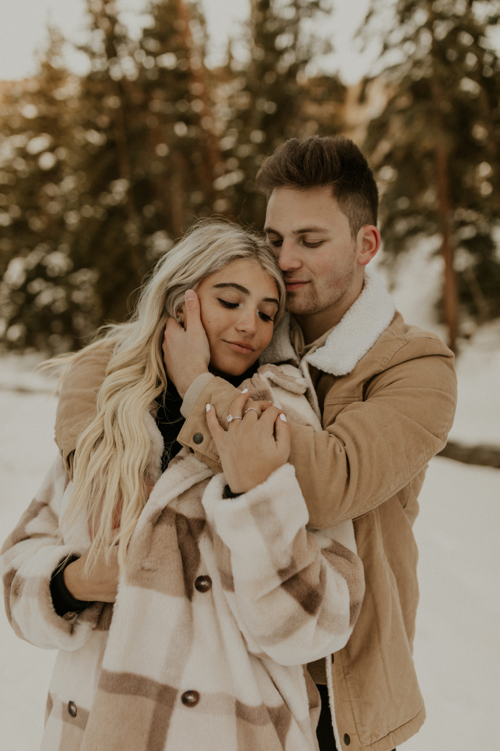 A snowy winter couples’ pregnancy announcement session while on vacation in the mountains of Vail, Colorado.