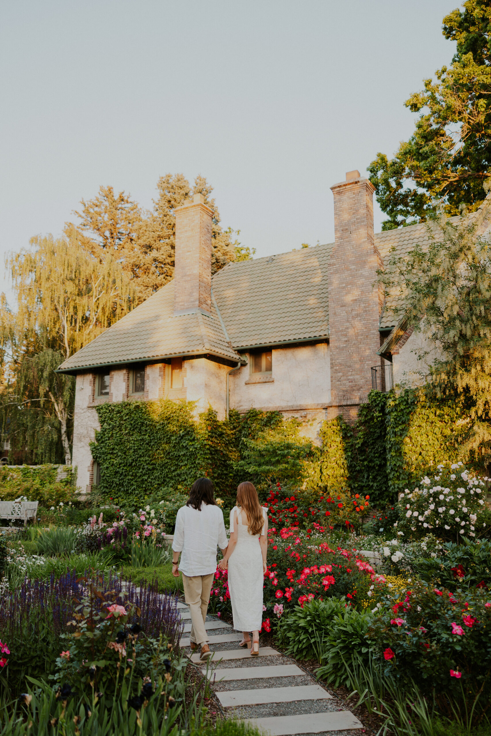 Soft and romantic garden engagement photos in Northern Virginia, couple walking through blooms