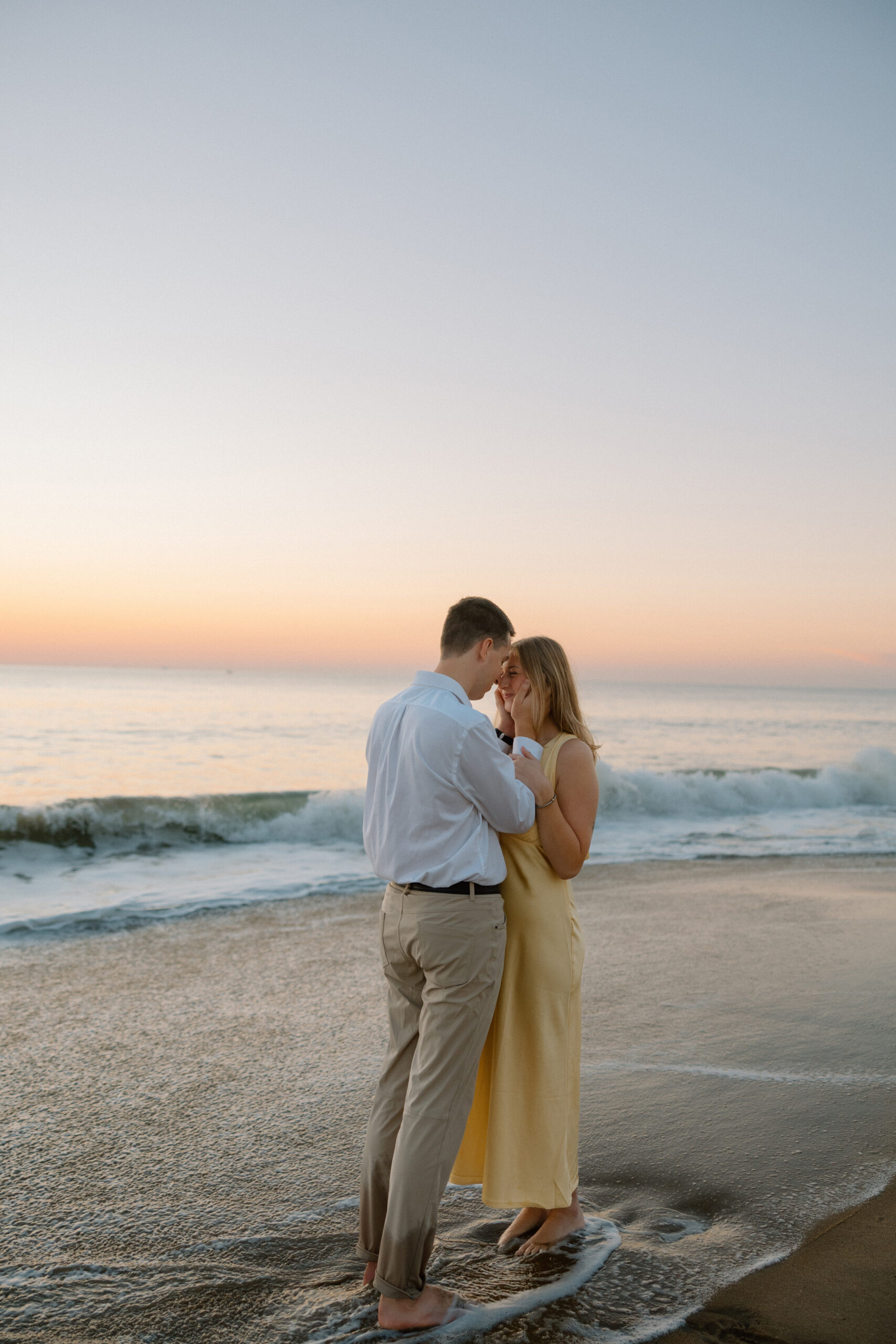 Couple by the ocean during blue hour couples photoshoot in Virginia Beach