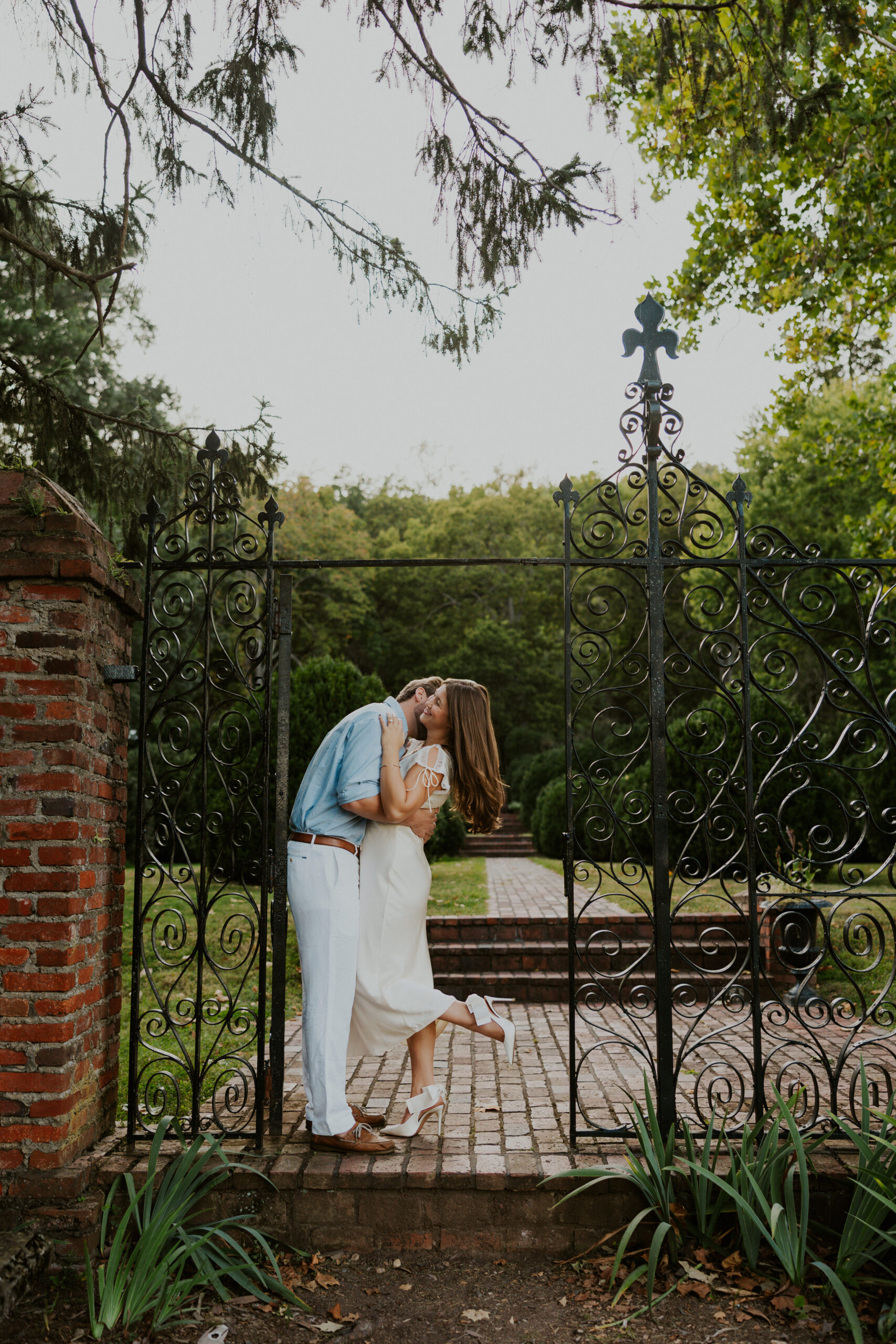 Engagement photo of couple embracing in entrance of the historic Morven Park mansion