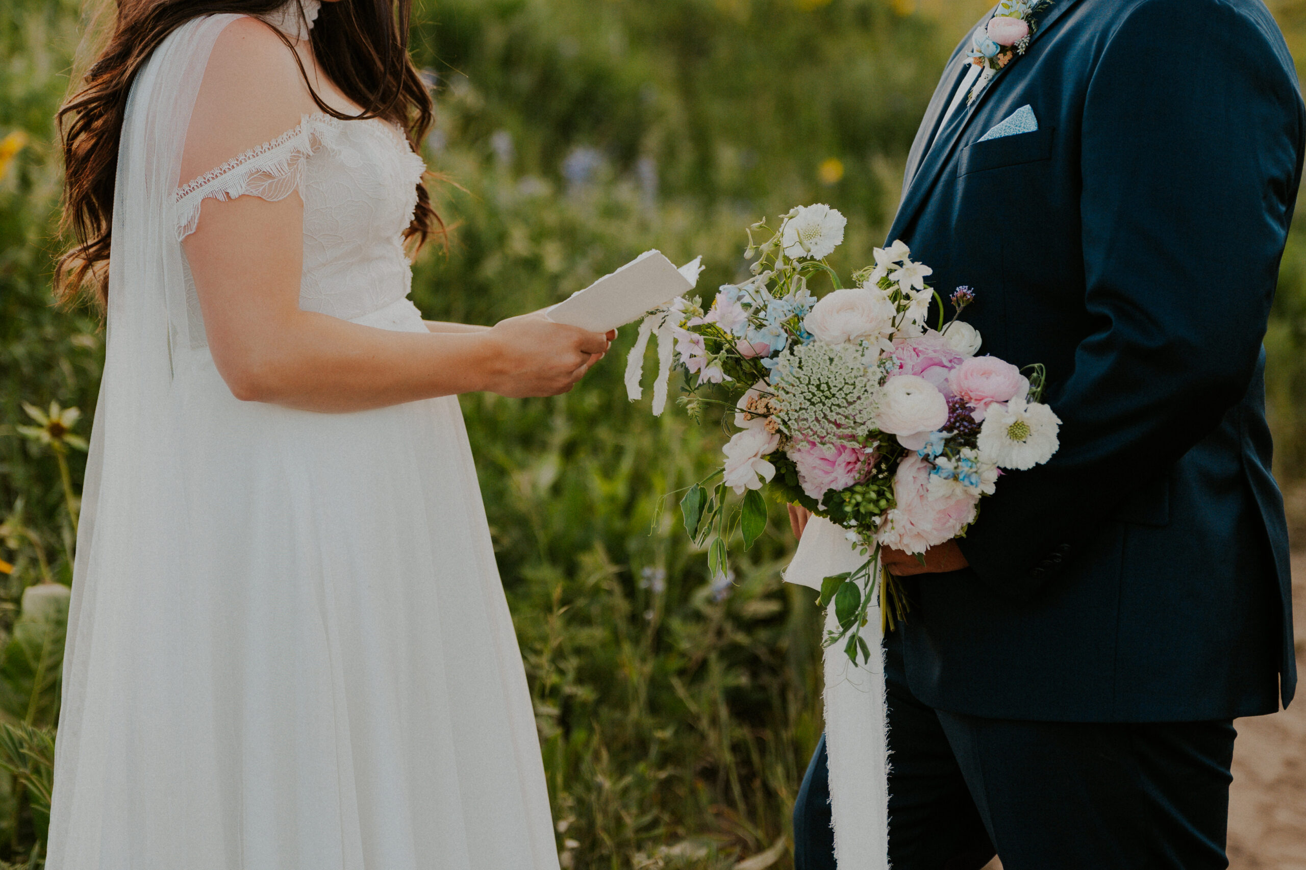 Couple exchanging vows during a Crested Butte Colorado wildflower elopement