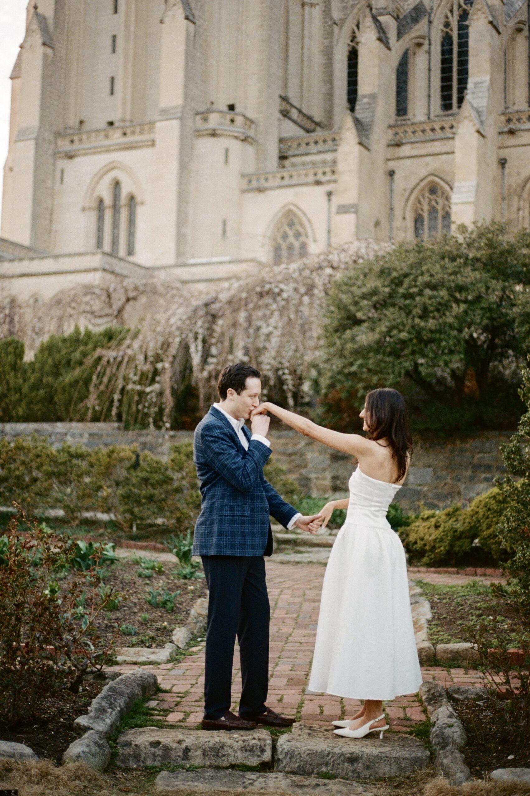 Luxury engagement session on 35mm film featuring couple in the architecture of Washington National Cathedral